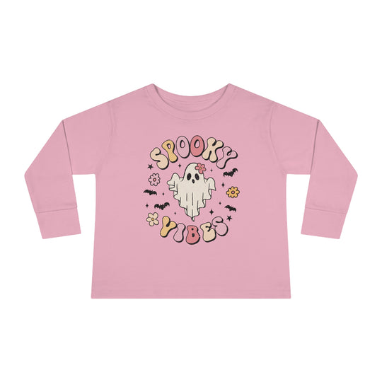 A spooky vibes toddler long sleeve tee featuring a pink shirt with a ghost and bats design. Made of 100% combed ringspun cotton, with topstitched ribbed collar and EasyTear™ label for comfort and durability.