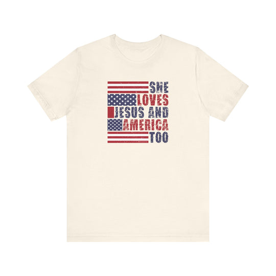 A She Loves Jesus and America Tee: A white t-shirt with red and blue text, featuring a classic unisex jersey fit. Made of 100% Airlume combed cotton, light fabric, ribbed knit collars, and tear away label.