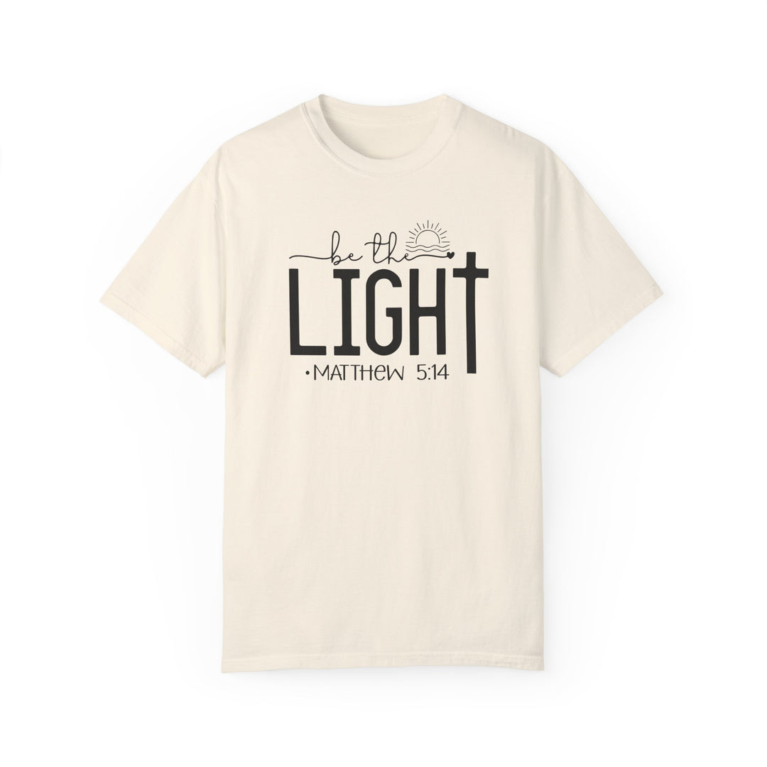 A white Be the Light Tee, crafted from 100% ring-spun cotton. Soft-washed and garment-dyed for coziness, with a relaxed fit and durable double-needle stitching. No side-seams for a sleek silhouette.