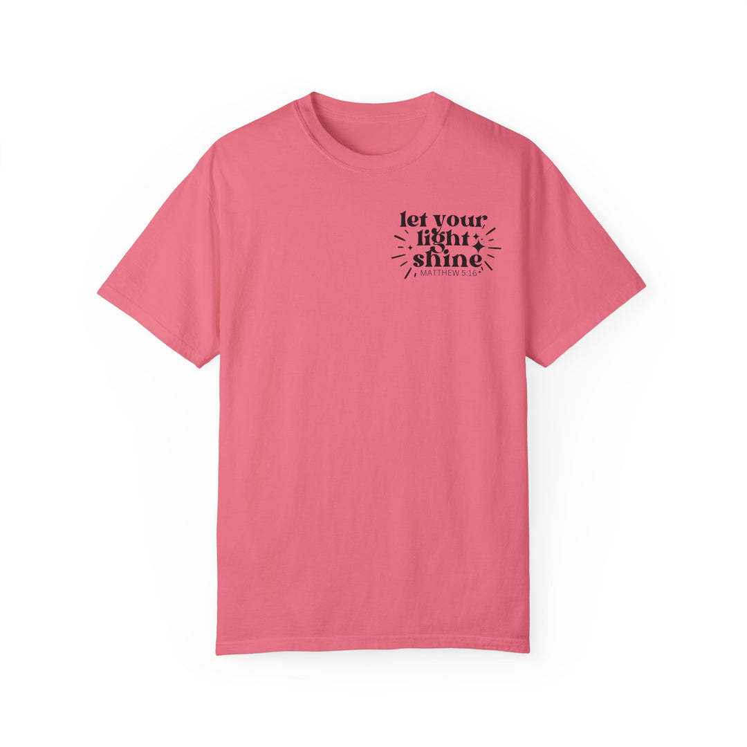 Let Your Light Shine Tee: Pink t-shirt with black text. 100% ring-spun cotton, garment-dyed for coziness. Relaxed fit, durable double-needle stitching, no side-seams. Sizes S to 3XL.