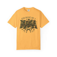 Mustard-yellow tee by Comfort Colors with GOD MADE ME A MAMA in camo font, featuring a bow, floral sprigs, and stars.