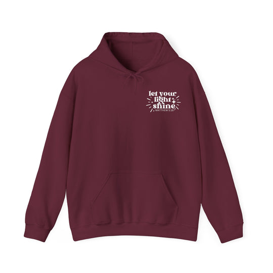 Unisex Let Your Light Shine Hoodie: Maroon sweatshirt with white text, kangaroo pocket, and matching drawstring. Cozy blend of cotton and polyester for warmth and comfort. Perfect for cold days. Classic fit, tear-away label.