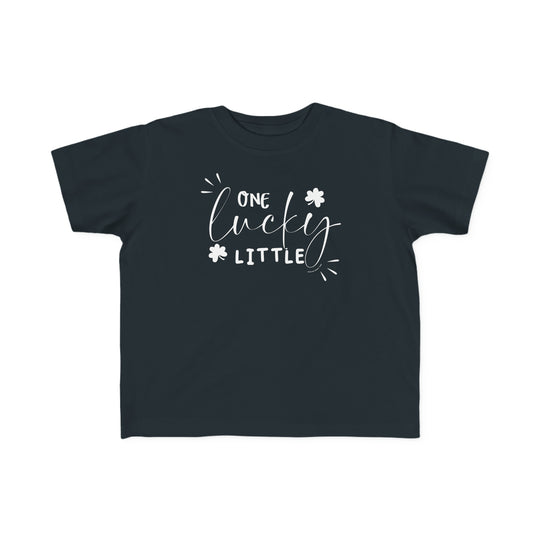 A toddler tee named One Lucky Little Tee in black with white text. Soft 100% combed ringspun cotton, light fabric, classic fit, tear-away label. Sizes: 2T, 3T, 4T, 5-6T.