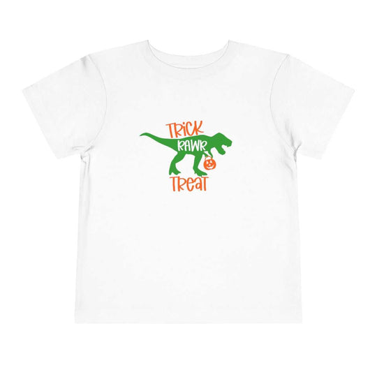 A Trick Rawr Treat Toddler Tee featuring a white dinosaur graphic on a short sleeve white t-shirt. Made of 100% Airlume combed and ringspun cotton for extra comfort. Toddler sizes: 2T, 3T, 4T, 5T.