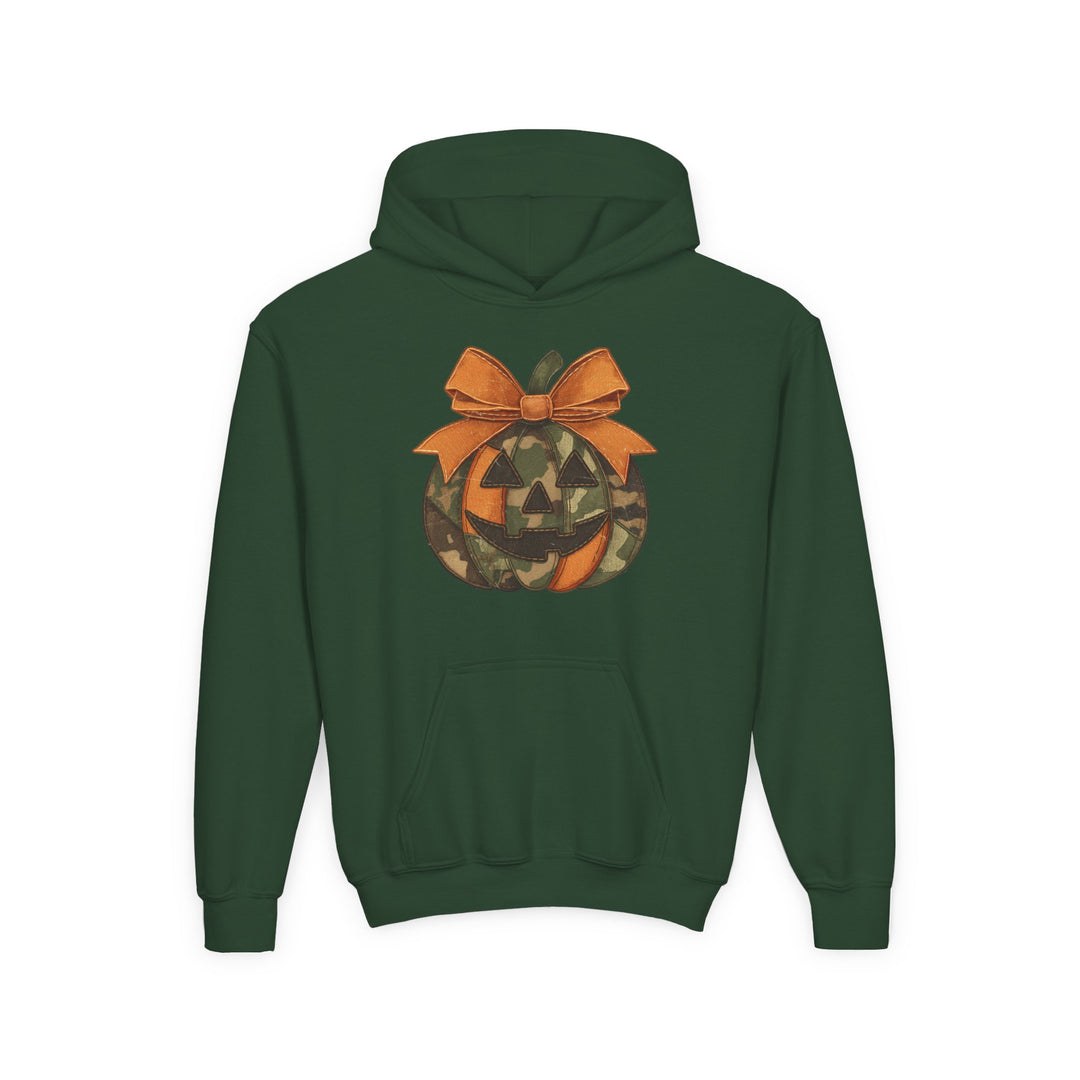 Jackie O Youth Hoodie: Dark green hoodie with a jack-o’-lantern featuring orange and camouflage segments, topped with an orange bow, and a kangaroo pocket.