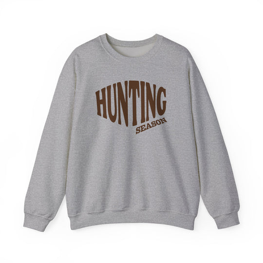Light-gray crewneck sweatshirt with HUNTING SEASON printed on chest, offering comfort and durability. Ideal for colder months, featuring ribbed collar and no side seams.