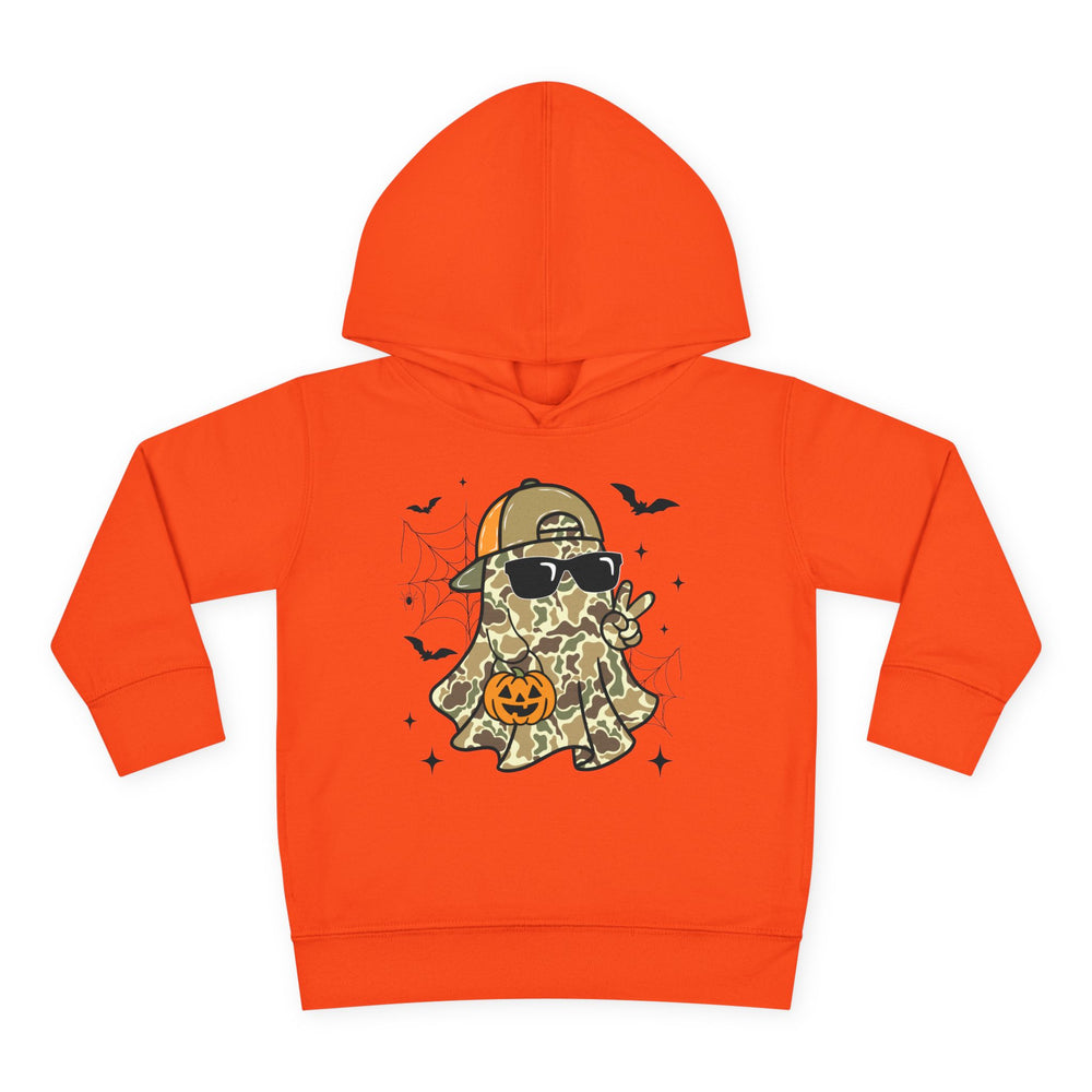 Candy Ghost Toddler Hoodie features a playful camouflage ghost with a cap, sunglasses, peace sign, and jack-o’-lantern, surrounded by bats and webs.