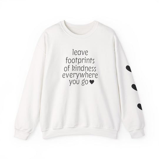 White crew-neck sweatshirt with leave footprints of kindness everywhere you go and black hearts on sleeve, offering comfort and style from Worlds Worst Tees.