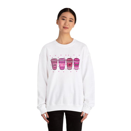 A unisex heavy blend crewneck sweatshirt featuring pink coffee cup designs, ideal for comfort. Made of 50% cotton and 50% polyester, with a ribbed knit collar and no itchy side seams. From Worlds Worst Tees.