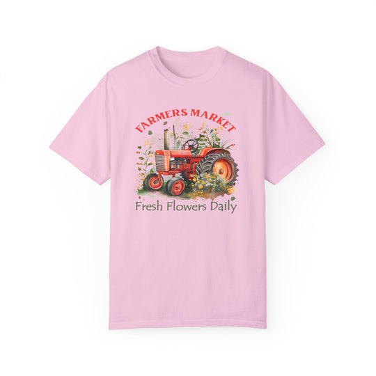 Alt text: Fresh Flowers Tee: A pink shirt featuring a tractor and plants, crafted from 100% ring-spun cotton. Relaxed fit, double-needle stitching, and seamless design for durability and comfort. Shop at Worlds Worst Tees for unique graphic t-shirts.
