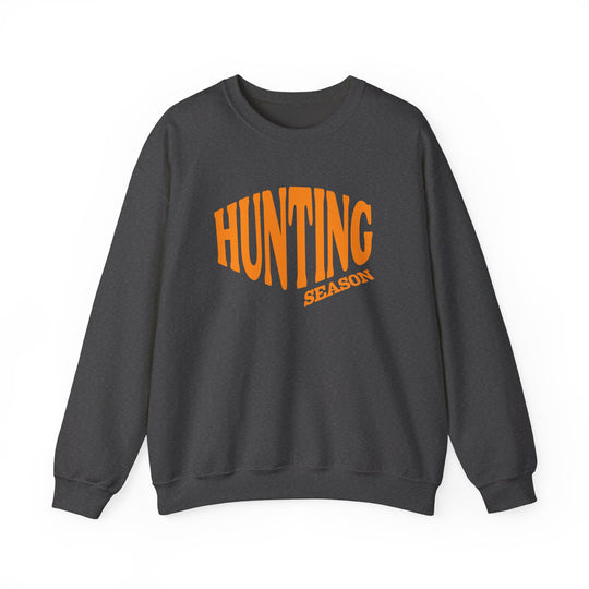 Dark charcoal-gray sweatshirt reads HUNTING in bold orange, SEASON beneath. Unisex, cozy blend, perfect for colder months, featuring durable stitching and a classic fit.