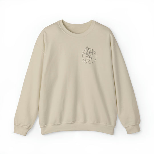 A unisex heavy blend crewneck sweatshirt featuring a logo design. Made of 50% cotton and 50% polyester, with a ribbed knit collar for shape retention. Comfortable and versatile.