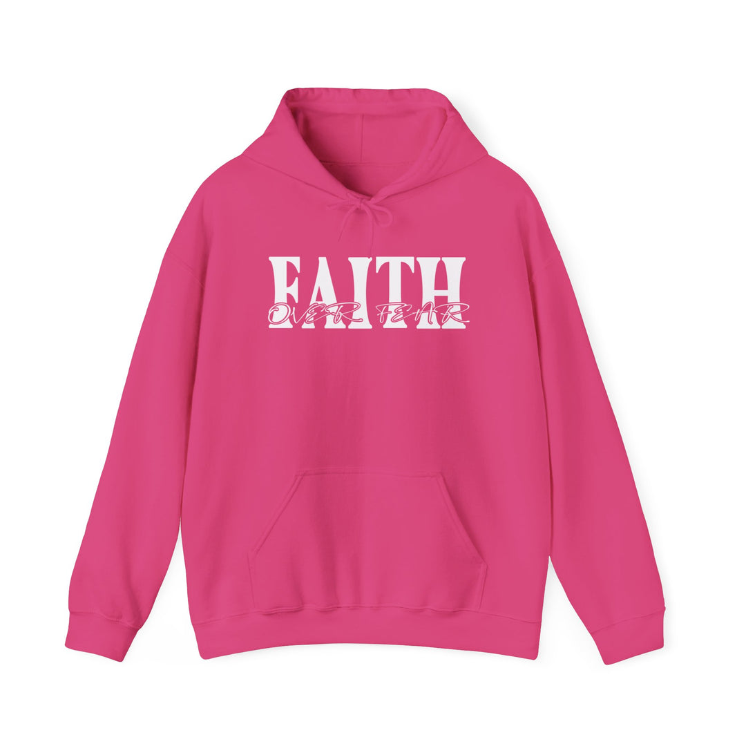 A pink unisex heavy blend hooded sweatshirt featuring Faith Over Fear text, kangaroo pocket, and matching drawstring. Plush, warm, and stylish, perfect for cold days. Made of 50% cotton, 50% polyester, with a classic fit.