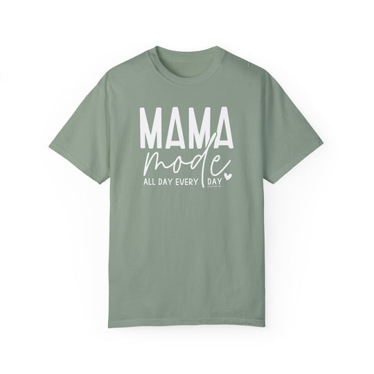 A green Mama Mode Tee, garment-dyed with ring-spun cotton for cozy wear. Relaxed fit, double-needle stitching, no side-seams for durability and shape retention.