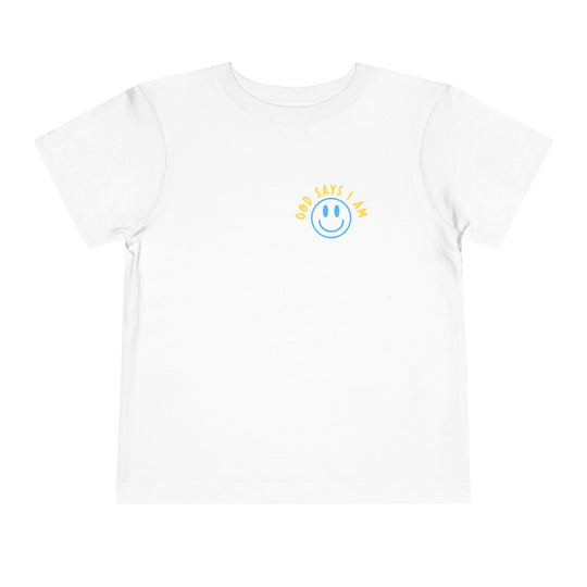 I AM Toddler Tee: A white, short-sleeved t-shirt featuring a blue smiley-face and GOD SAYS I AM in yellow on the chest. Made from soft, comfortable cotton.
