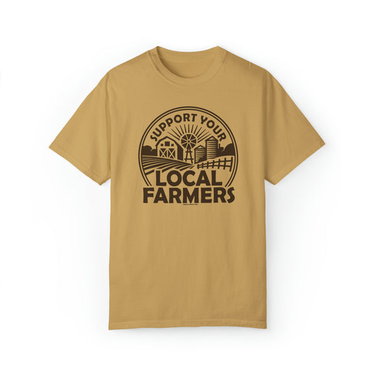 A tan t-shirt featuring a graphic design of a local farmers market logo. Unisex, garment-dyed sweatshirt made of 80% ring-spun cotton and 20% polyester. Relaxed fit with rolled-forward shoulder and back neck patch.