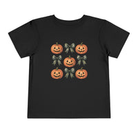 Pumpkins and Bows Toddler Tee features a 3x3 grid with smiling jack-o’-lanterns and ribbon bows, perfect for a comfy, custom kids' wardrobe staple.