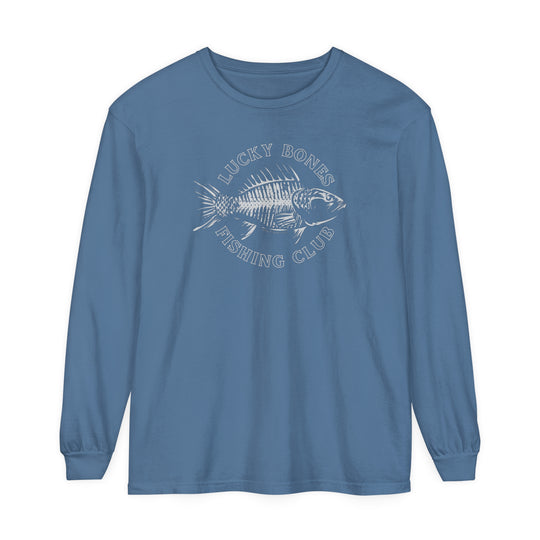 A Lucky Bones Fishing Club Long Sleeve Tee featuring a fish graphic on a blue shirt. Made of 100% ring-spun cotton with a relaxed fit for comfort. Perfect for casual settings.