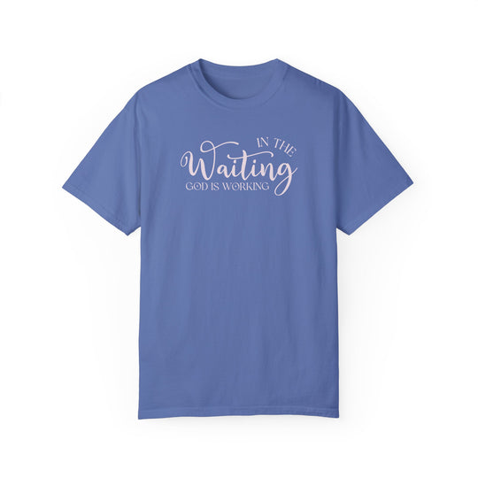 Relaxed fit God is Working Tee, garment-dyed in blue with white text. 100% ring-spun cotton, soft-washed for coziness, double-needle stitching for durability, no side-seams for shape retention. Sizes S-4XL.