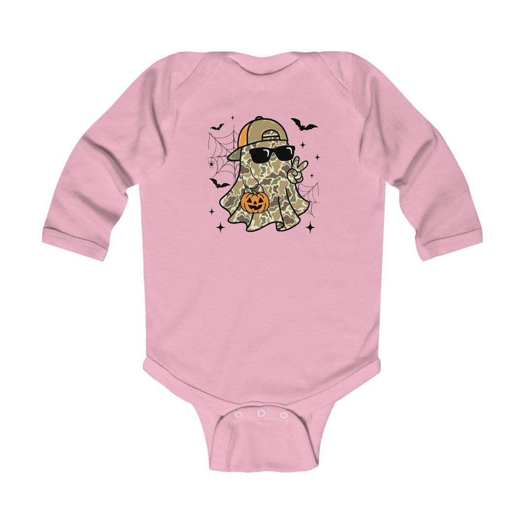 Candy Ghost Long Sleeve Onesie featuring a cartoon ghost with camouflage, sunglasses, and cap, holding a jack-o’-lantern, amidst spider-webs, bats, and sparkles.