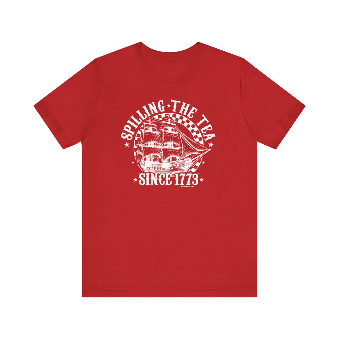 Red shirt featuring a white ship and stars graphic, part of the Spilling the Tea Since 1773 Tee collection at Worlds Worst Tees. Unisex jersey tee with ribbed knit collar, 100% Airlume combed cotton, retail fit.