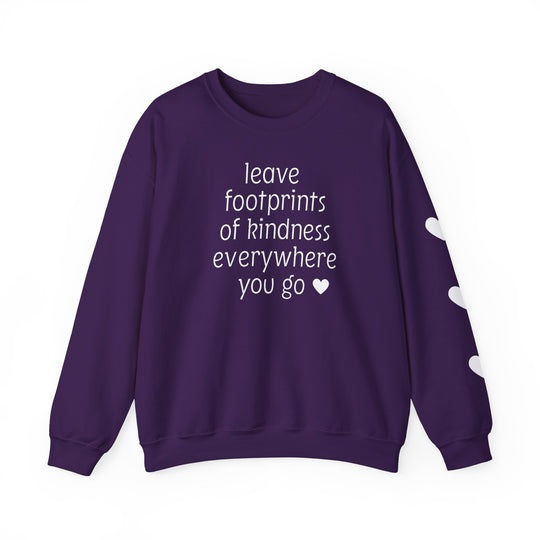 Purple crew-neck sweatshirt with white text: leave footprints of kindness everywhere you go ♥ and three white hearts on one sleeve.