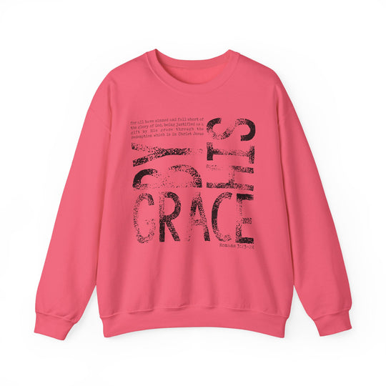 Solid-pink crewneck sweatshirt labeled By His Grace Hoodie features GRACE print and Romans 3:23–24 verse, offering comfort with durable, ethically made fabric.