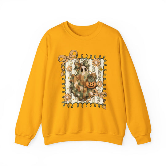 Quilted Ghost Crew: Mustard-yellow sweatshirt with whimsical ghost graphic, camo-style sheet, bow, jack-o’-lantern bucket, framed by ribbons and daisies. Cozy, durable, unisex fit.