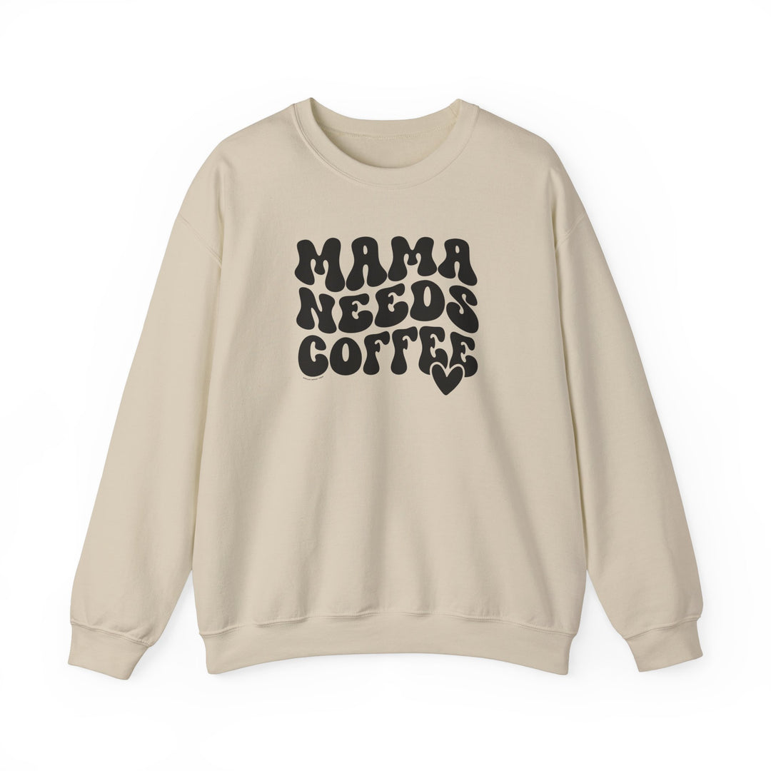 A unisex heavy blend crewneck sweatshirt titled Mama Needs Coffee Crew in beige with black text. Made of 50% cotton, 50% polyester, ribbed knit collar, no itchy side seams, loose fit, medium-heavy fabric.