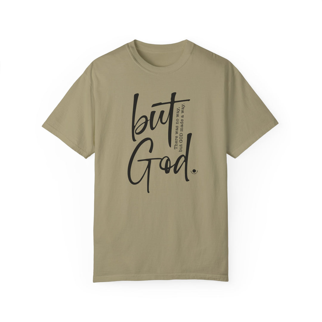Relaxed fit But God Tee in tan with black text. 100% ring-spun cotton, garment-dyed for coziness. Double-needle stitching, no side-seams for durability and shape. Ideal daily wear.