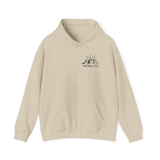 A beige unisex heavy blend hooded sweatshirt with a logo of mountains and sun. Made of 50% cotton and 50% polyester, featuring a kangaroo pocket and matching drawstring. Perfect for cold days.