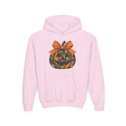 Jackie O Youth Hoodie: Light-pink hoodie featuring woodland camouflage jack-o’-lantern with orange bow, kangaroo pocket, made of ultra-soft, preshrunk fleece, blending comfort and unique style.