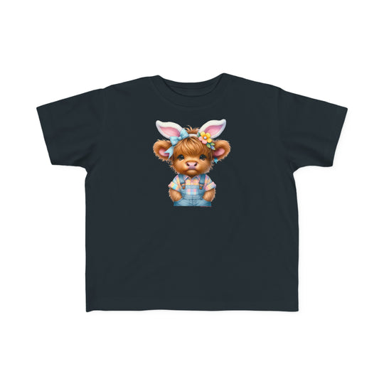 Easter Cow Toddler Tee: A black t-shirt featuring a cartoon cow in bunny ears, perfect for sensitive skin. Made of 100% combed ringspun cotton, light fabric, classic fit, tear-away label, and true-to-size.