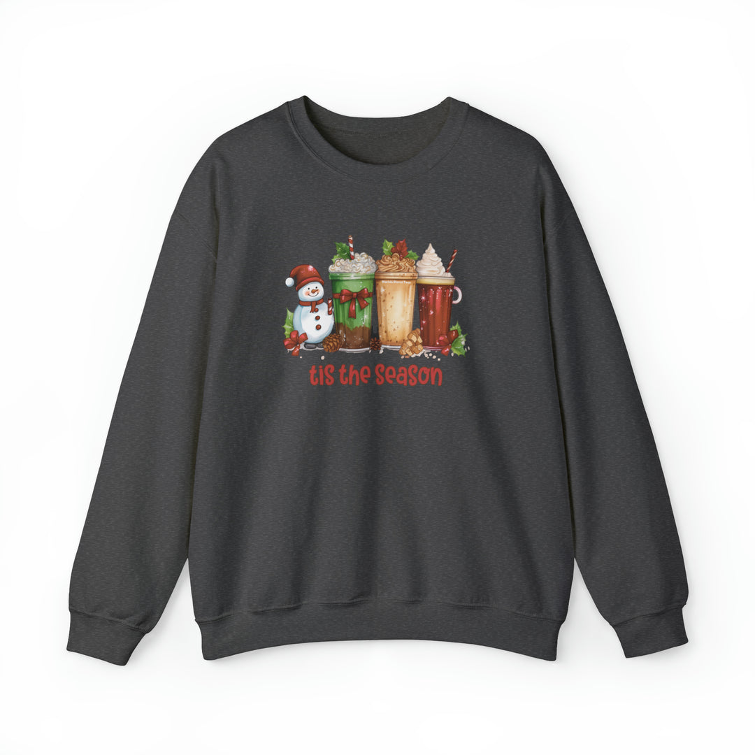 A unisex heavy blend crewneck sweatshirt featuring a festive Tis the season Christmas Crew design with various drinks, a snowman, and a cup. Made of 50% cotton, 50% polyester for comfort and durability.