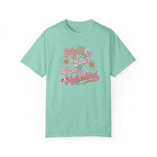 A relaxed fit Mind Your Motherhood Tee, 100% ring-spun cotton, garment-dyed for coziness. Double-needle stitching for durability, no side-seams for a tubular shape. Sizes S-4XL.