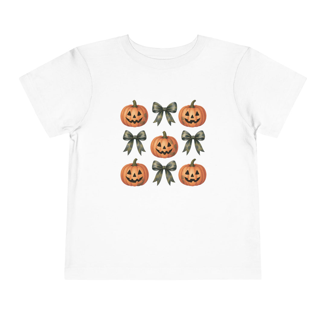 Pumpkins and Bows Toddler Tee featuring a 3×3 grid of jack-o’-lanterns and ribbon bows, perfect for Halloween-themed, comfortable wear. Made of 100% Airlume cotton.