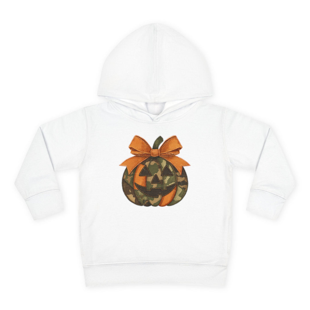 Jackie O Toddler Hoodie features a Halloween-themed jack-o’-lantern applique with orange and camouflage segments, a smiling face, and an orange bow on a white hoodie.