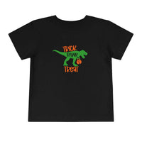 A Trick Rawr Treat Toddler Tee featuring a dinosaur design on black fabric. Made of 100% Airlume combed and ring-spun cotton for comfort. Ideal for kids.