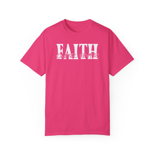 A Faith Over Fear Tee, a pink shirt with white text, crafted from 100% ring-spun cotton. Garment-dyed for coziness, featuring a relaxed fit and durable double-needle stitching. Ideal for daily wear.