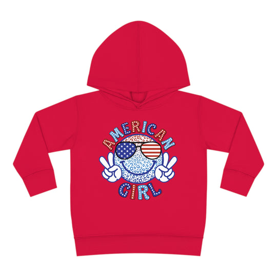 American Girl Toddler Hoodie featuring a red design with a smiley face and sunglasses. Jersey-lined hood, cover-stitched details, and side pockets for durability and coziness. Ideal for kids aged 2 to 6.