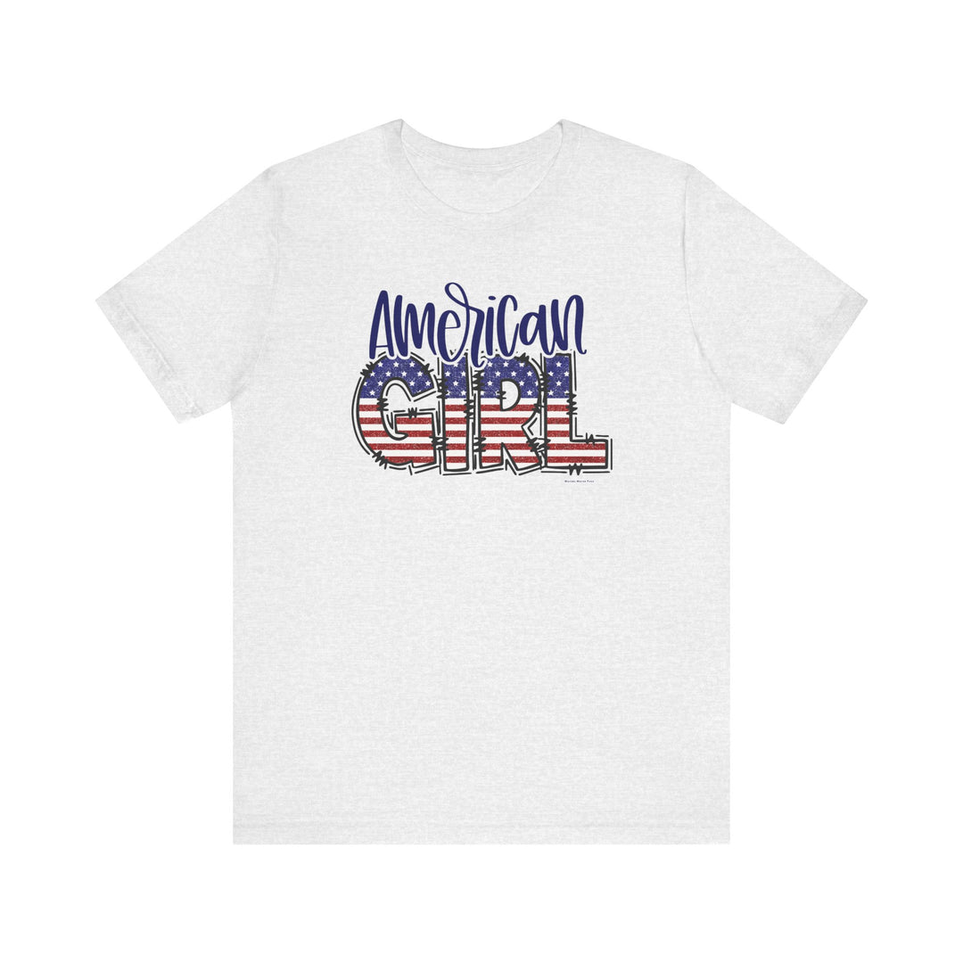 A classic American Girl Tee, featuring a white shirt with red, white, and blue text and flag design. Unisex jersey tee made of 100% Airlume combed and ringspun cotton, with ribbed knit collars and taping on shoulders for durability.