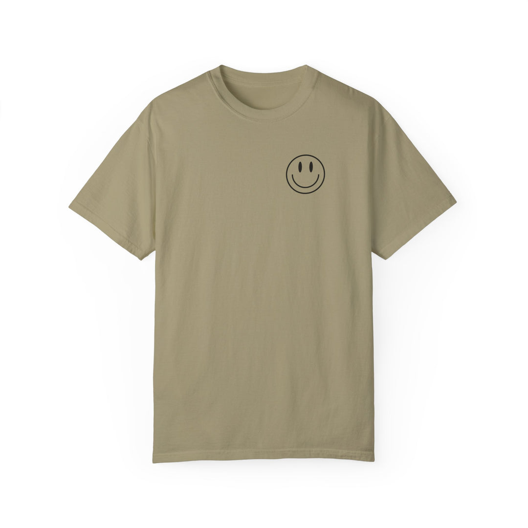 A tan Be the reason Tee t-shirt with a smiley face graphic. 100% ring-spun cotton, garment-dyed for extra coziness. Relaxed fit, double-needle stitching for durability. From Worlds Worst Tees.