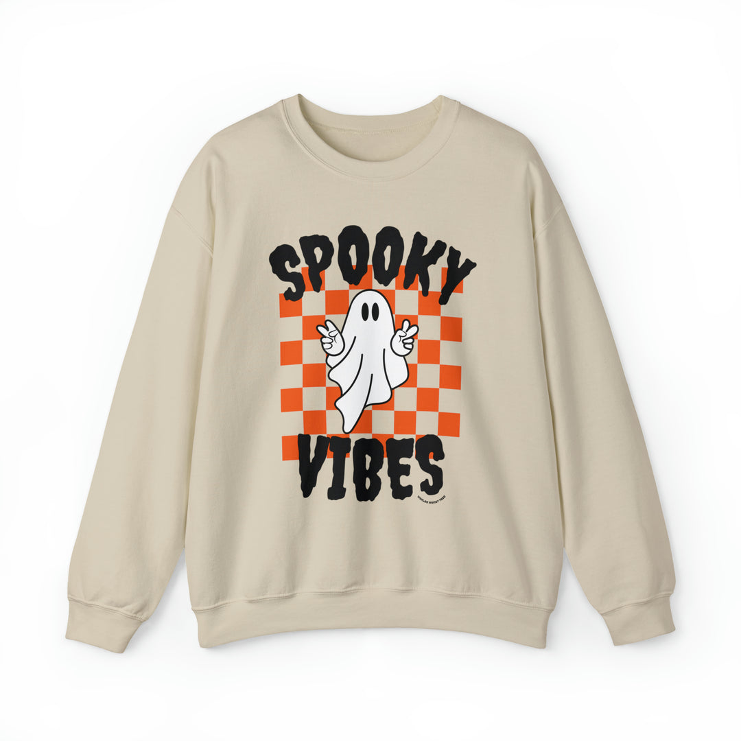 A tan crewneck sweatshirt featuring a white ghost design, ideal for all occasions. Made of 50% cotton and 50% polyester, with ribbed knit collar and no itchy side seams. Product title: SPOOKY VIBES CREW.
