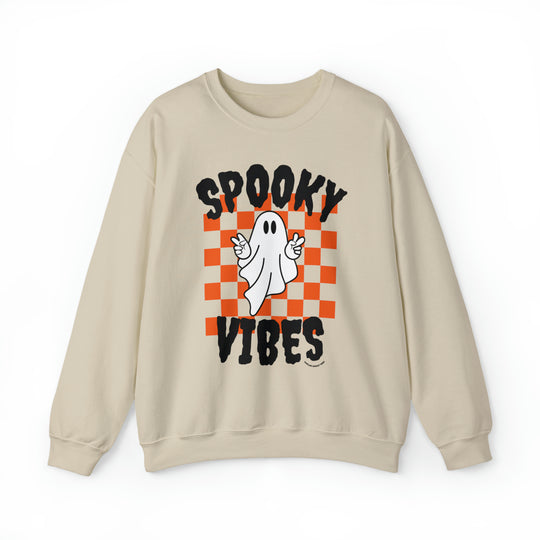 A tan crewneck sweatshirt featuring a white ghost design, ideal for all occasions. Made of 50% cotton and 50% polyester, with ribbed knit collar and no itchy side seams. Product title: SPOOKY VIBES CREW.