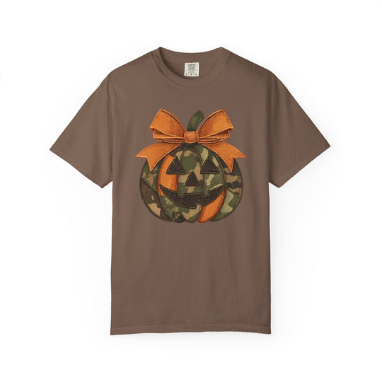 Jackie O Tee: Brown short-sleeve T-shirt featuring a jack-o’-lantern with camo and orange panels, topped with a textured orange bow.
