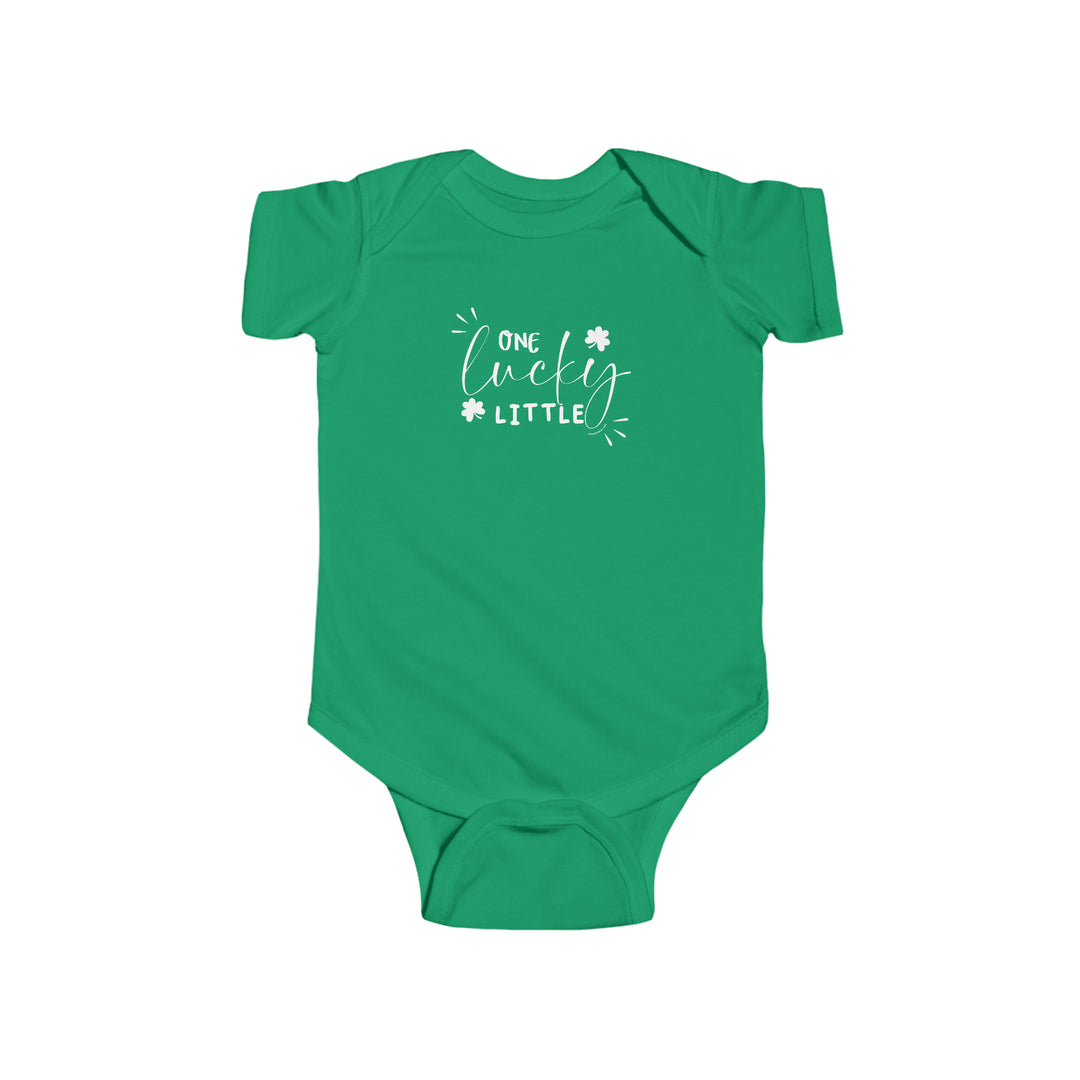 A green baby bodysuit with white text, featuring One Lucky Little Onesie from Worlds Worst Tees. Made of 100% cotton, light fabric, with ribbed knit bindings and plastic snaps for easy changing access.