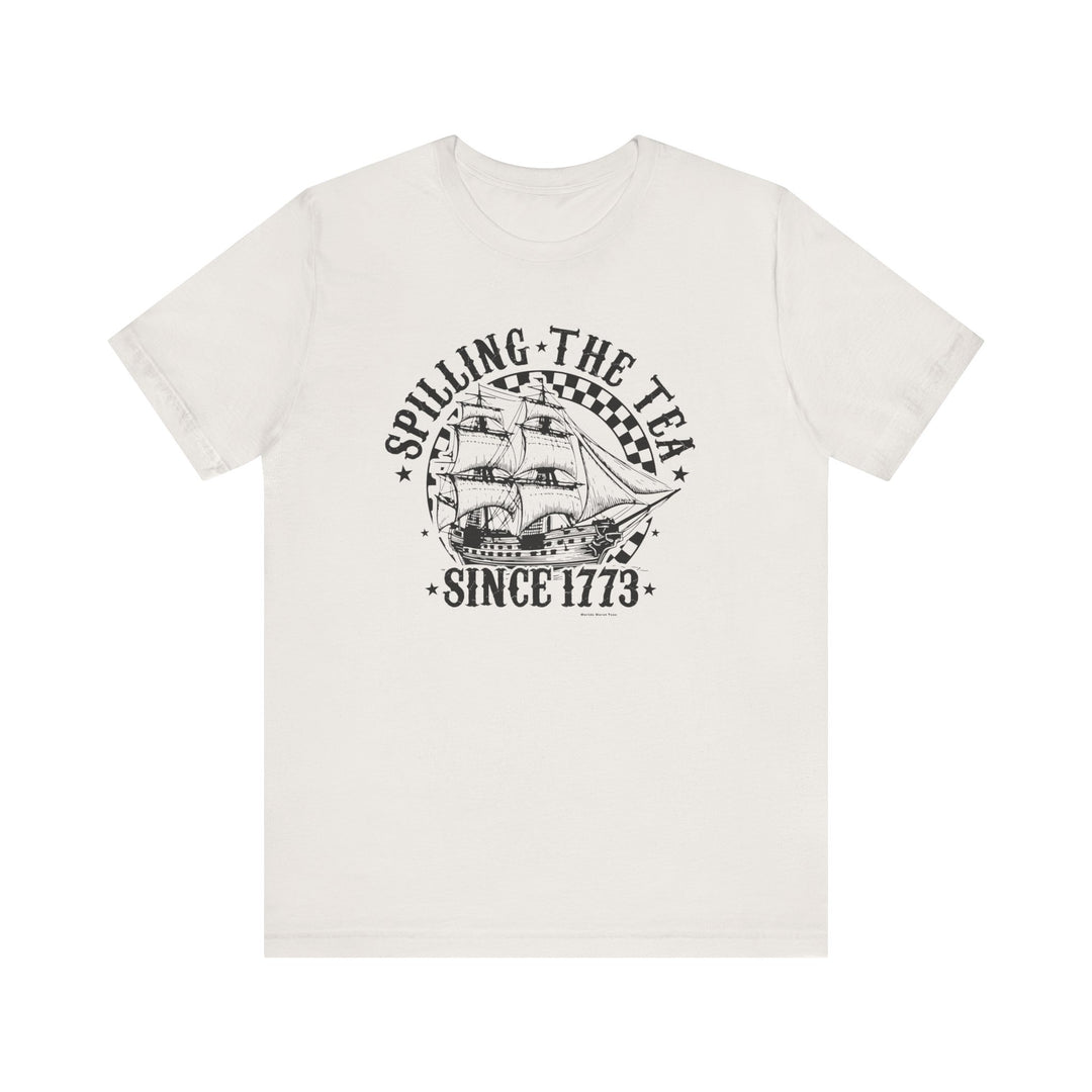 A white tee featuring a ship graphic and text, part of the Spilling the Tea Since 1773 collection at Worlds Worst Tees. Unisex jersey tee with ribbed knit collars, 100% cotton, and tear-away label.