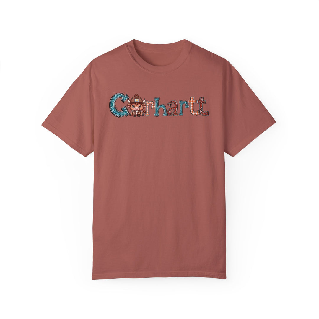 Alt text: Cowhartt Tee: A relaxed-fit t-shirt with a cartoon cow wearing a hat, made of 100% ring-spun cotton for durability and comfort. Medium weight, garment-dyed fabric with double-needle stitching for a cozy daily wear option.