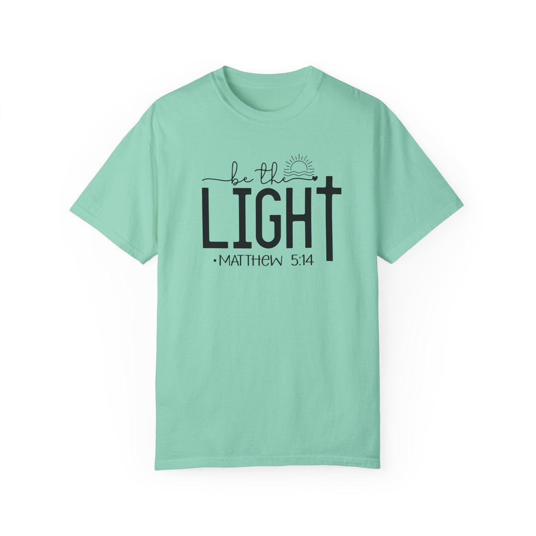 Be the Light Tee: Light green shirt with black text, 100% ring-spun cotton, garment-dyed for coziness, relaxed fit, durable double-needle stitching, no side-seams for shape retention. From Worlds Worst Tees.