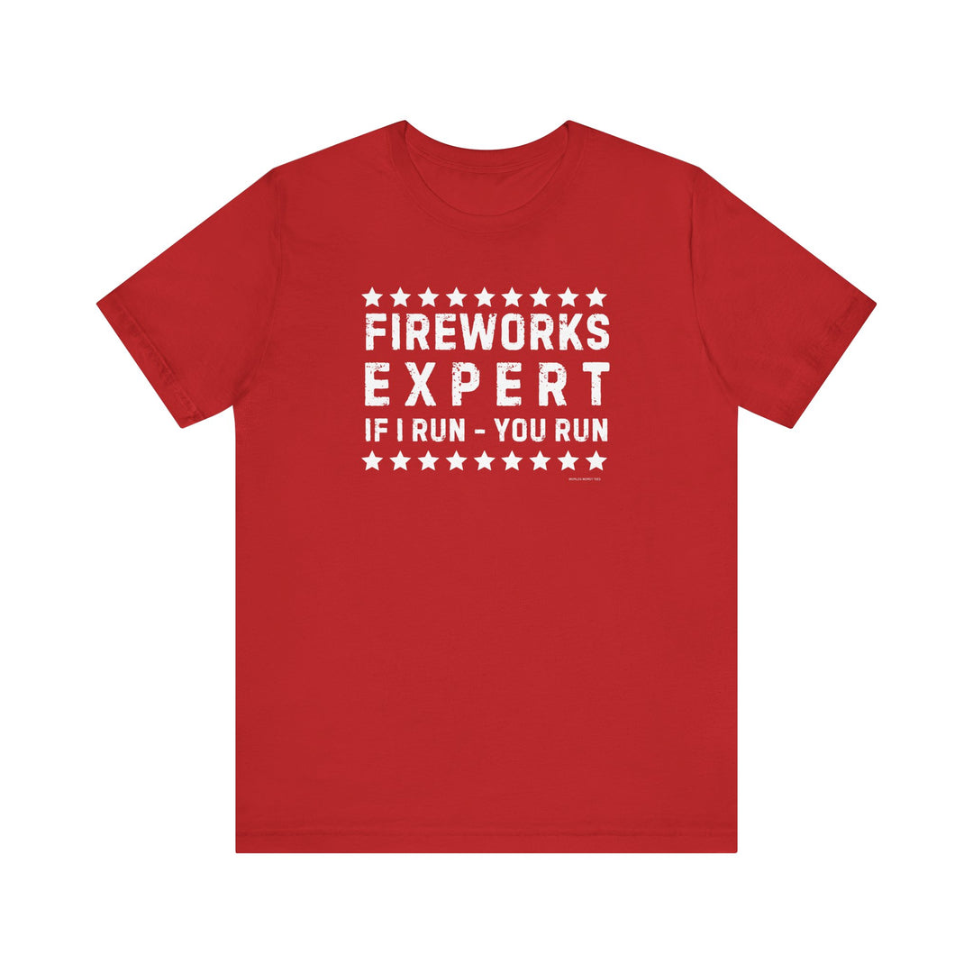 A Firework Expert Tee, a red shirt with white text, in XS-3XL sizes. 100% Airlume combed cotton, retail fit, tear away label, ribbed knit collars, taping on shoulders, dual side seams for shape retention.